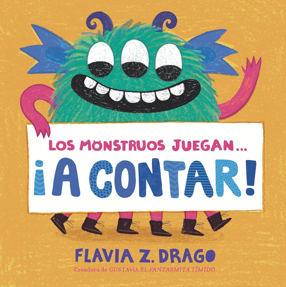 The vibrant cover of A contar! by Flavia Z. Drago features a colorful, three-eyed monster holding a sign with the title on an orange background. This delightful toddler board book is from the author of Gustavo, el Fantasmita Tímido.