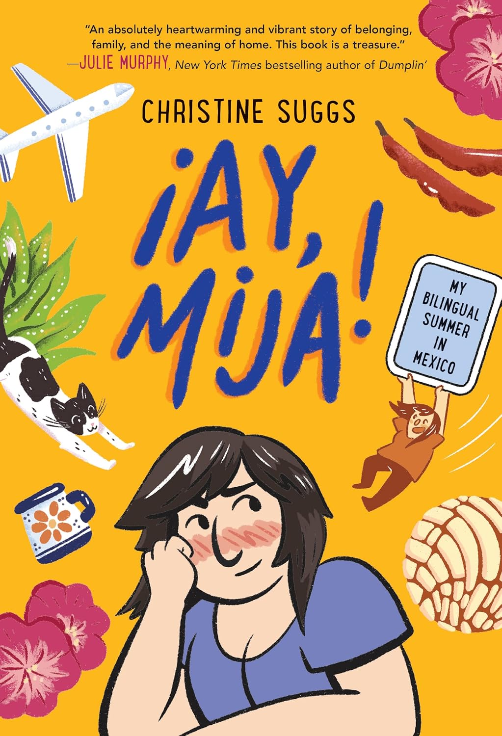 The graphic novel ¡Ay, Mija! by Christine Suggs features an illustrated cover showcasing a joyful dark-haired person with a cat, leaves, traditional Mexican food, an airplane, and two people holding a sign titled My Bilingual Summer in Mexico, celebrating family heritage.