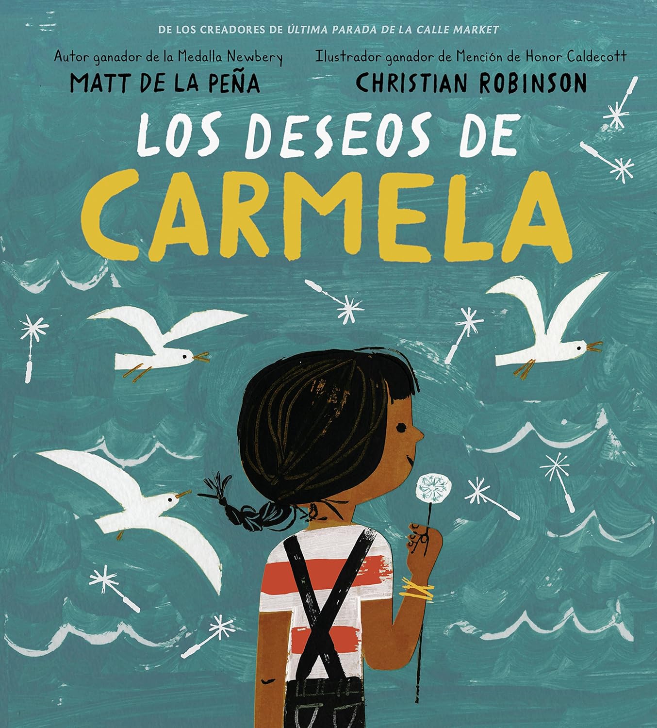 The cover of Los Deseos de Carmela by Matt de la Peña and Christian Robinson features an illustration of young Carmela with a dandelion, gazing at seagulls against a teal backdrop, imagining birthday wishes in the vibrant city.