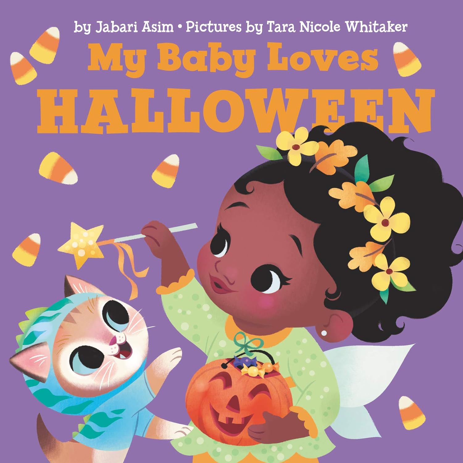 The My Baby Loves Halloween illustrated board book cover shows a baby in a green costume holding a pumpkin bucket, waving candy corn with a wand, while a cat in a blue outfit sits nearby. The book is written by Jabari Asim and illustrated by Tara Nicole Whitaker.