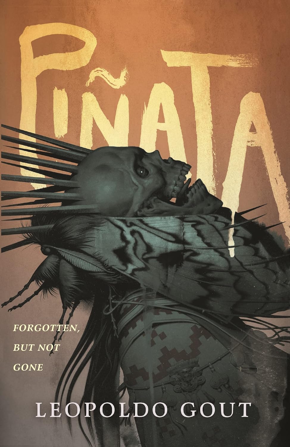 The cover of Pinata by Leopoldo Gout showcases a dark, abstract design inspired by Mexico, highlighting a skeletal figure wrapped in patterned fabric. The text reads Forgotten. But Not Gone. A gradient of brown shades echoes the grandeur of an ancient cathedral.