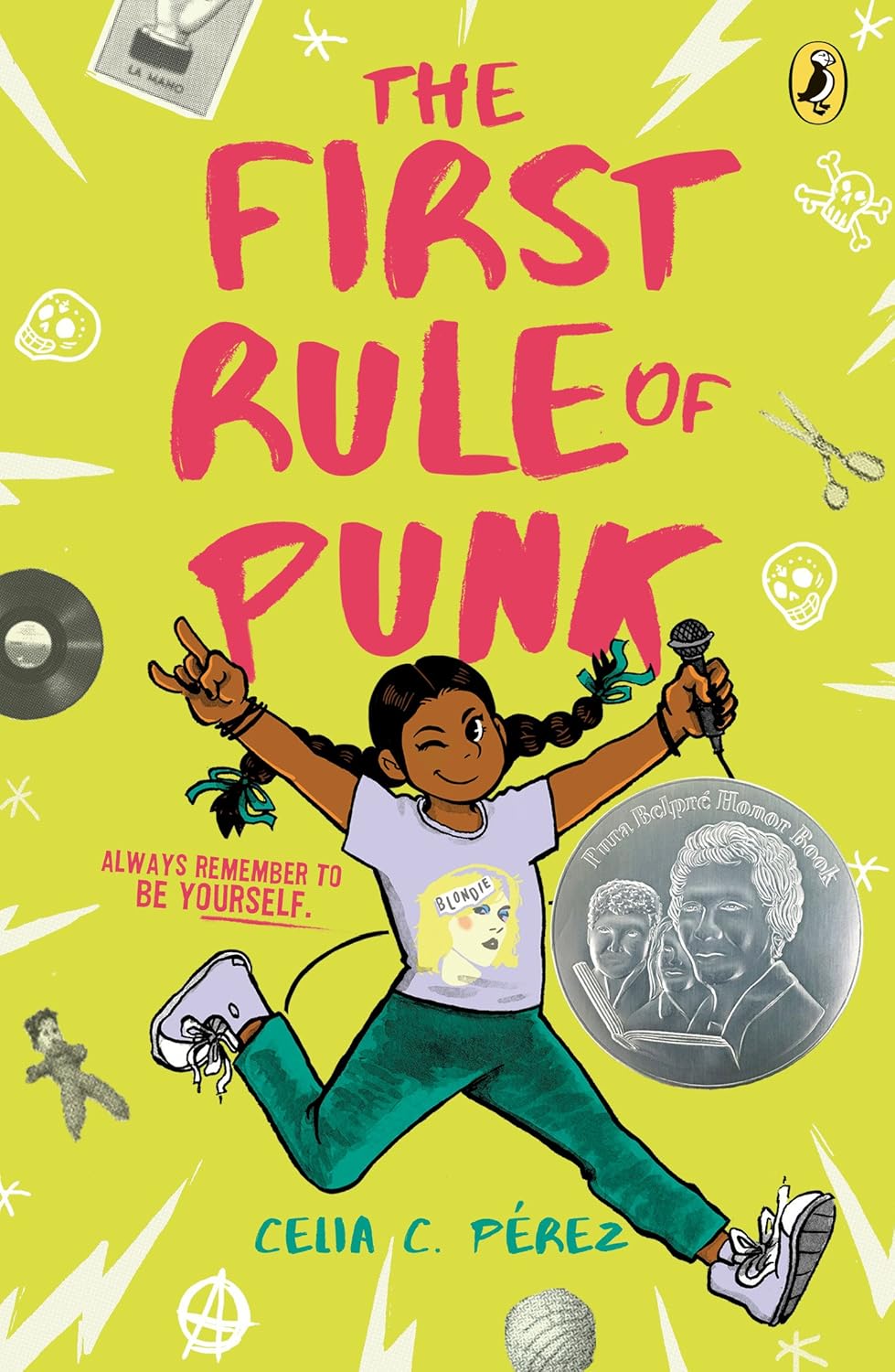 The cover of The First Rule of Punk by Celia C. Pérez showcases a braided girl jumping with a microphone, expressing her passion for punk rock. The vibrant green background is filled with punk-themed elements like records, scissors, and skulls, capturing the essence of middle school vibes.