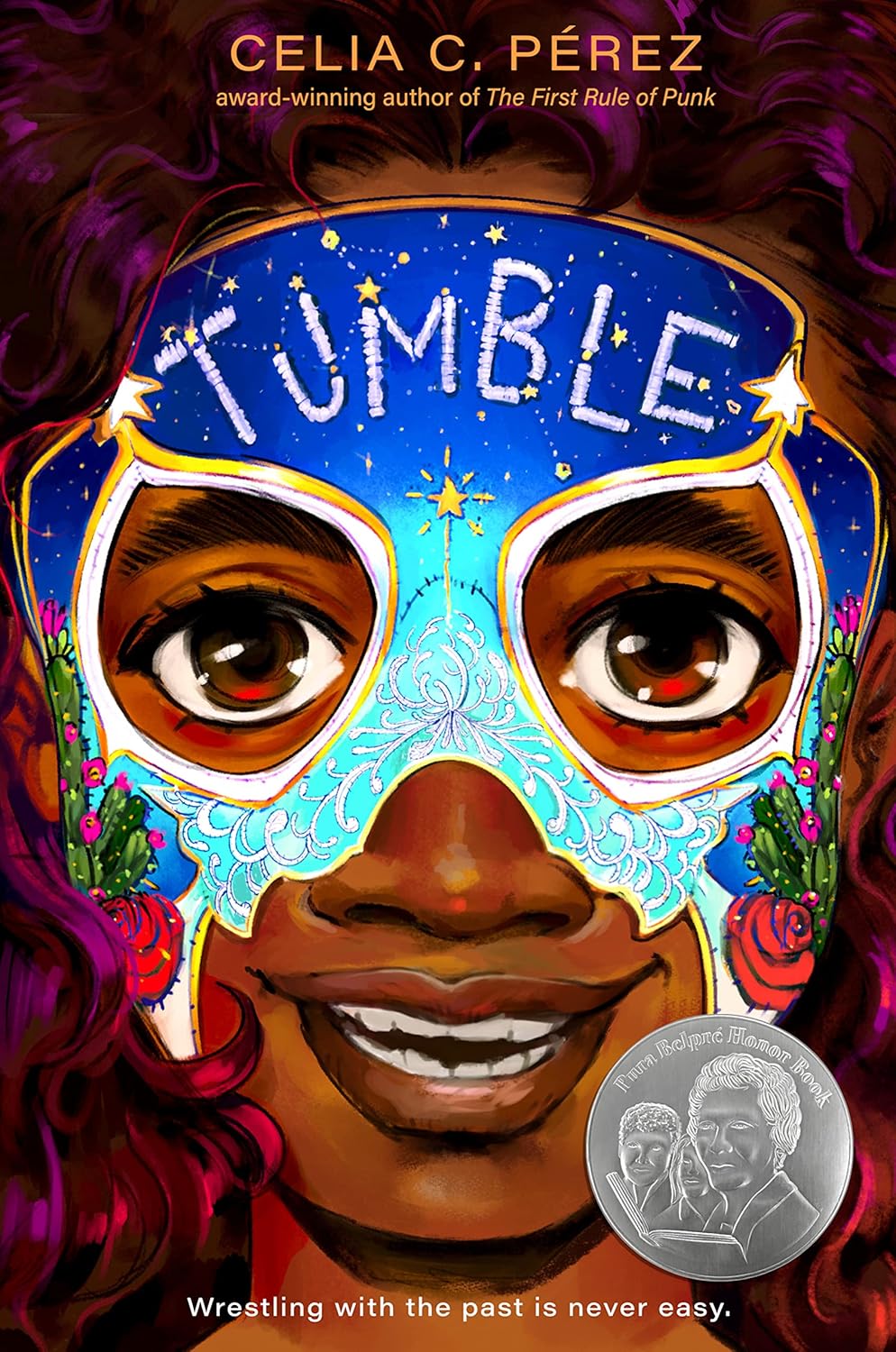 A colorful book cover for Tumble showcases a close-up of a young girl in a decorative luchador mask. The starry background adds mystique, and a silver award seal is in the bottom right corner.