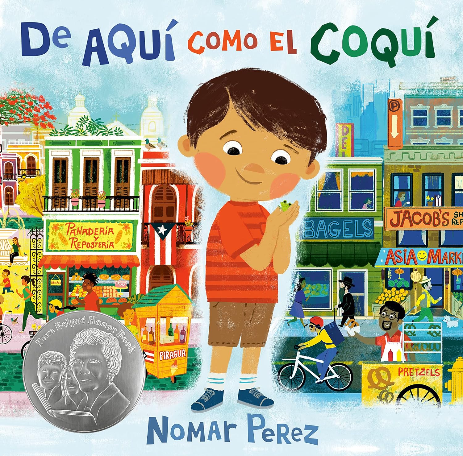 The book cover of de Aquí Como El Coquí by Nomar Perez shows a worried young boy standing in front of a lively cityscape reminiscent of Puerto Rico, with a silver seal on the left that might suggest a Pura Belpré honor.