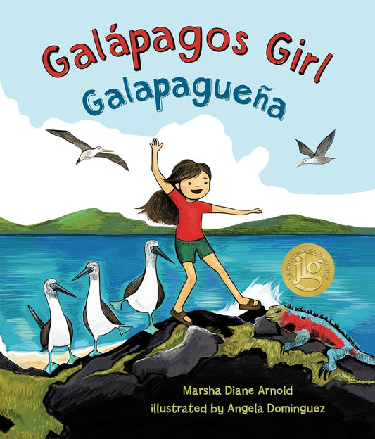 The book cover for Galápagos Girl by Marsha Diane Arnold, illustrated by Angela Dominguez, shows a girl on Galápagos rocks with birds and ocean in the background. A gold award seal is present. This bilingual picture books full title includes Galapagueña.