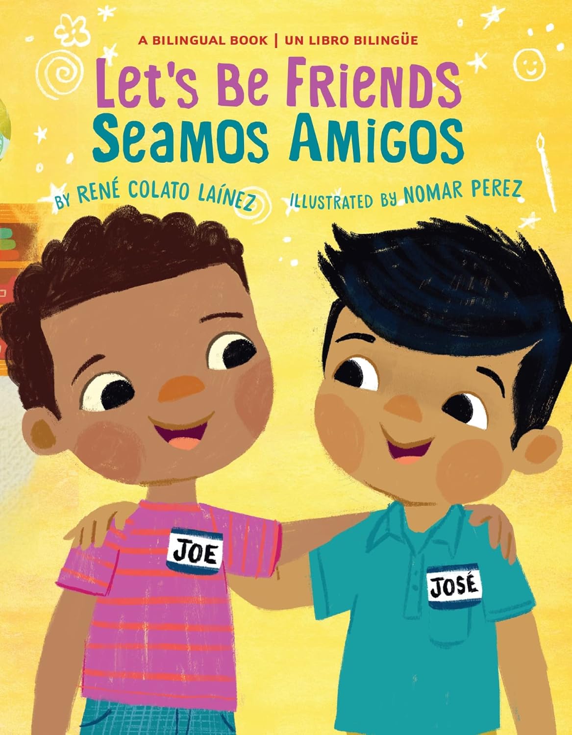 Illustration of two bilingual toddlers smiling and embracing. One wears a pink striped shirt labeled Joe, the other a blue shirt labeled José. On a yellow background, the text Lets Be Friends / Seamos Amigos is displayed, ideal for the friendship board book titled Seamos amigos.